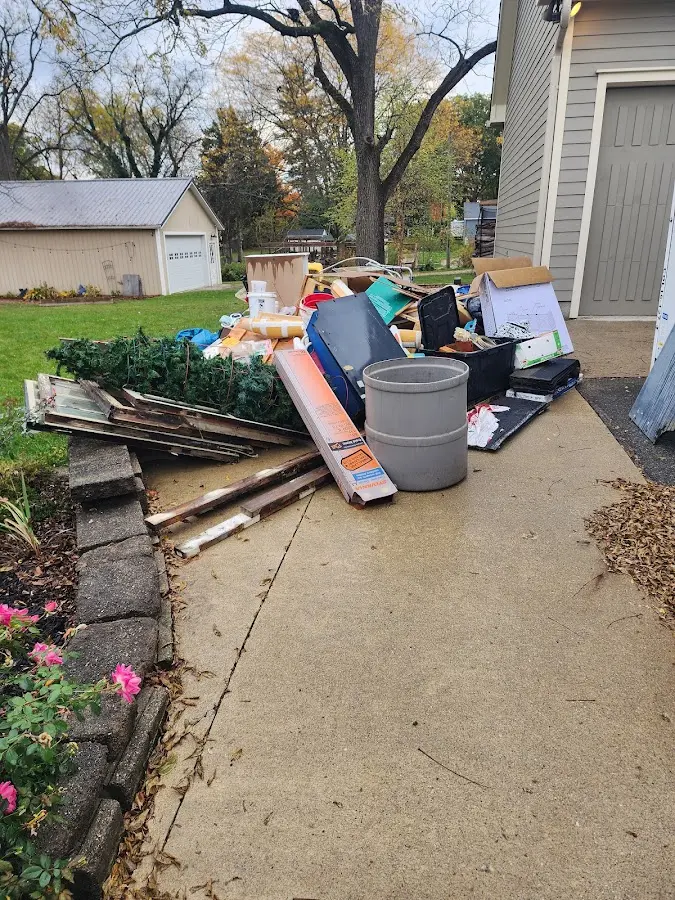 Dumpster being loaded with debris for 12 Yard Dumpster Rental in Norfolk